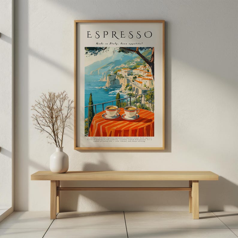 May include: A framed vintage travel poster featuring the word "ESPRESSO". The poster shows a coastal Italian scene with two cups of coffee on a table with an orange and white striped tablecloth. The text "Made in Italy, buon appetito!" is also visible.