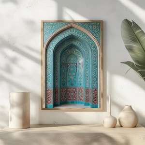 May include: Framed print of an arched architectural design with intricate turquoise and red floral patterns. The artwork features a series of nested arches, creating a sense of depth and symmetry. The frame is a light wood color.