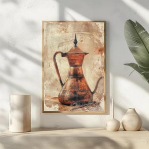 May include: A framed print of a copper coffee pot with a long spout and handle. The pot has a textured surface and is set against a sepia-toned background with brown splatters. The print is in a wooden frame.