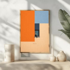 May include: A framed art print with a minimalist design. The artwork features a person reading by a window, set against a backdrop of orange, blue, and beige geometric shapes. The word "Pause" is printed at the bottom.