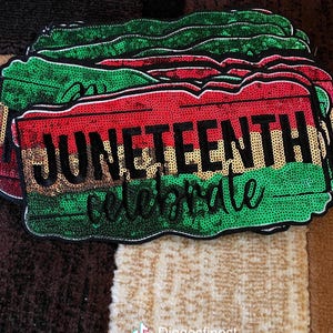 May include: A stack of Juneteenth patches with a red, green, and gold sequined design. The patches feature the words "JUNETEENTH celebrate" in black script. The patches are on a patterned surface.
