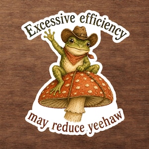 May include: A die-cut sticker featuring a green frog wearing a brown cowboy hat and a red bandana, sitting atop a large red mushroom with white spots. The text "Excessive efficiency" is arched above and "may reduce yeehaw" is below the frog.
