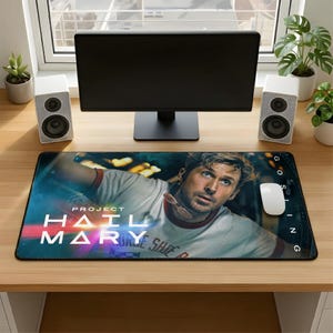 May include: A rectangular mouse pad featuring a movie poster design with the text "PROJECT HAIL MARY" and a portrait of a man. The pad is black with a colorful background and a white mouse.