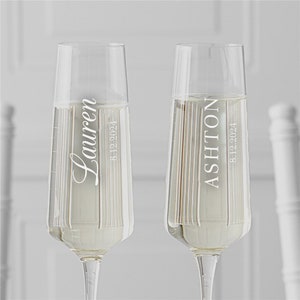 May include: Two personalised champagne flutes with the names "Lauren" and "Ashton" and the date "8.12.2024" etched on them.
