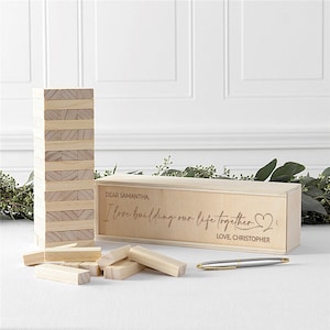 May include: Wooden box with a personalised message that reads "Dear Samantha, I love building our life together." The box contains a wooden block stacking game.