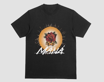 May include: Black t-shirt featuring a graphic of a red rose with yellow accents, set against a yellow sunburst design. The word "MANÁ" is written in white script below the graphic. The shirt is a classic crew neck style.