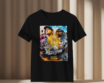 May include: Black t-shirt featuring a colorful graphic of baseball players with the words "World Series" and "2025". The design includes images of players in baseball caps and uniforms, set against a vibrant background.