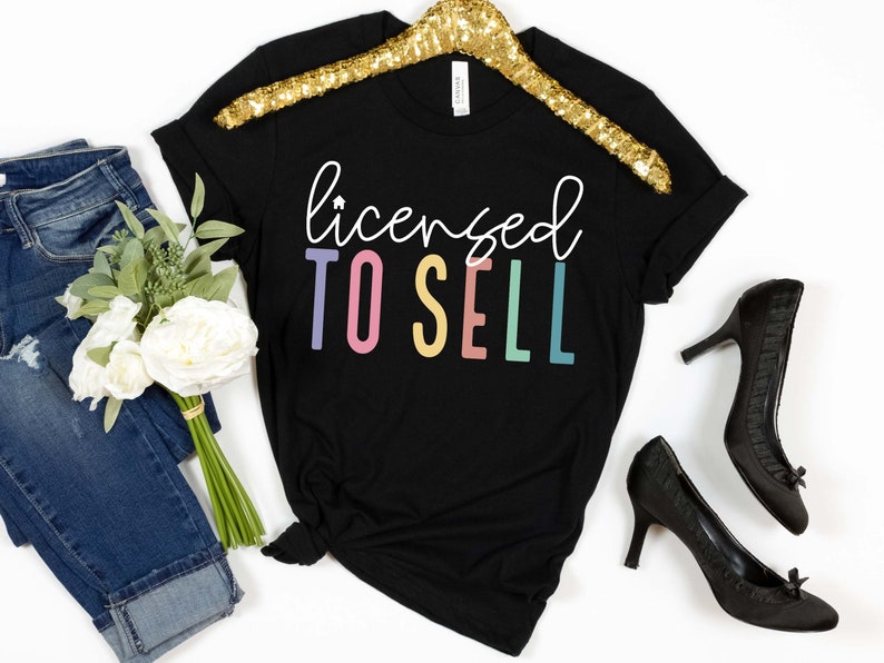 May include: Black t-shirt with the text "licensed to sell" in rainbow colors.