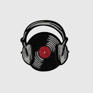 May include: An embroidered patch featuring a black vinyl record with a red center label, positioned behind a pair of grey over-ear headphones. The design uses black, grey, and red thread to create a detailed graphic of music equipment.