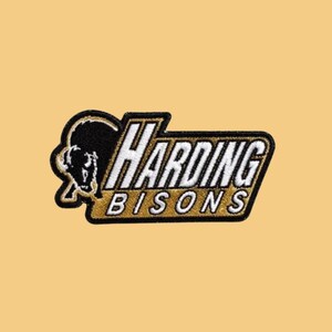 May include: An embroidered patch featuring a black bison silhouette on the left and the white text HARDING BISONS outlined in black and gold. The patch has a black border and a gold-colored background within the text area, creating a bold design.