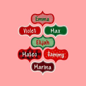 May include: Seven decorative labels with scalloped edges, each featuring a unique pattern and a name embroidered in white or green. The labels include the names Emma, Violet, Max, Elijah, Mateo, Sammy, and Marina, displayed on a solid pink background.