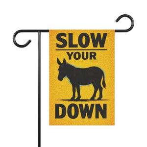 May include: A white ceramic mug with a black handle and the text "But First, Coffee" in a bold, black font. The mug is filled with a dark liquid, likely coffee, and sits on a light-colored surface.