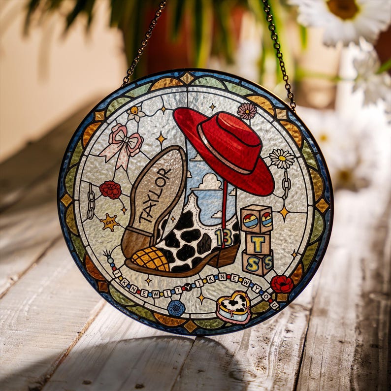May include: A circular stained glass suncatcher featuring a red hat, a cow-print cowboy boot with the number 13, and a boot sole labelled TAYLOR. It includes blocks with letters T, S, and a heart, plus the text I KNEW IT I KNEW YOU.