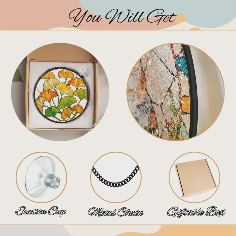 May include: A circular stained glass suncatcher featuring yellow and green ginkgo leaves, a clear suction cup, a black metal chain, and a brown cardboard box. The text "You Will Get", "Suction Cup", "Metal Chain", and "Giftable Box" is visible.