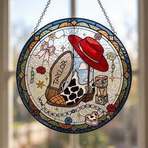 May include: A circular stained glass suncatcher featuring a cow-print cowboy boot with the number 13, a red hat, and stacked blocks with the letters T, S, and S. The text TAYLOR is on the boot sole, and I KNEW YOU is on a beaded string.