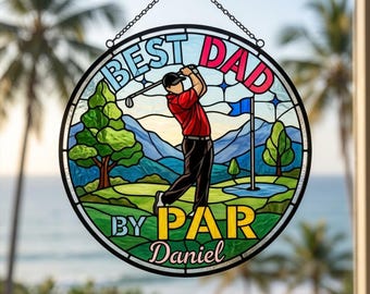 Puede incluir: Vidriera redonda con temática de golf. El diseño presenta a un golfista en acción, con las palabras "BEST DAD BY PAR" y el nombre "Daniel". La obra de arte incluye una escena de campo de golf con árboles, agua y una bandera.