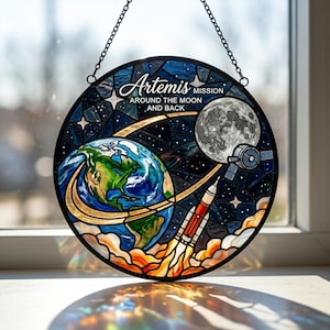 May include: A white ceramic mug with a black handle and the text "But First, Coffee" in a black, handwritten-style font. The mug is on a white surface.