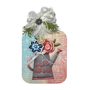May include: A rectangular wall plaque featuring a gray watering can with red polka dots and the text ENJOY SPRING. The design includes painted red and blue flowers, a white ribbon bow, and green foliage accents against a musical note background.