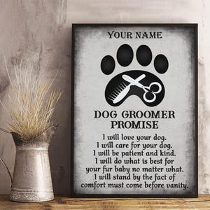 May include: A framed print with a paw print, comb, and scissors graphic, and the text "Dog Groomer Promise." The text includes promises to love, care for, and be patient with dogs. The top of the print says "Your Name."