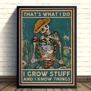 May include: Framed poster featuring a skeleton wearing a straw hat and surrounded by cacti and birds. The skeleton's ribcage is filled with succulents. Text reads "THAT'S WHAT I DO, I GROW STUFF AND I KNOW THINGS."