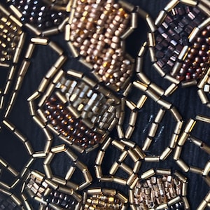 Luxury vintage evening wrap with intricate glass beading.