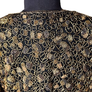 Close up of hand-finished edges on a beaded formal jacket.
