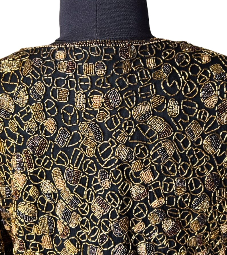 Close up of hand-finished edges on a beaded formal jacket.