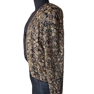 Open front vintage beaded evening jacket on a black mannequin.