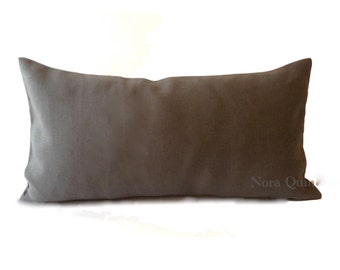 May include: A rectangular, solid gray pillow with a soft, textured appearance. The pillow is a neutral color, suitable for various decor styles. The pillow is approximately 24 inches long and 12 inches wide.