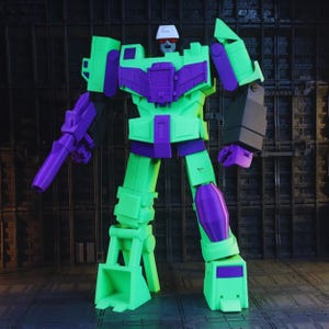 May include: A brightly colored, articulated robot toy in shades of green, purple, and black. The robot has a white helmet, a purple weapon, and a detailed mechanical design. The toy is standing upright, showcasing its various components and joints.