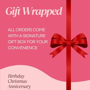 The image is a promotional poster for a gift wrapped with a signature gift box, featuring a red ribbon bow on a pink background.