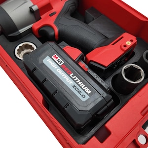 May include: A red and black cordless impact wrench kit. The kit includes a red impact wrench, a black battery pack labeled "M18 REDLITHIUM HIGH OUTPUT XC6.0", and various black sockets, all housed in a red case.