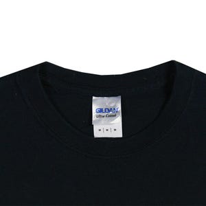 May include: Close-up of a black t-shirt collar with a white tag. The tag reads "GILDAN Ultra Cotton" and has three "M" size labels. The shirt is made of a soft, comfortable material.