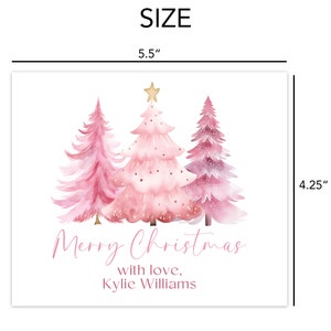 a christmas card with pink trees and a gold star