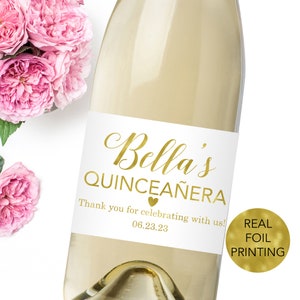 a bottle of wine with some pink flowers