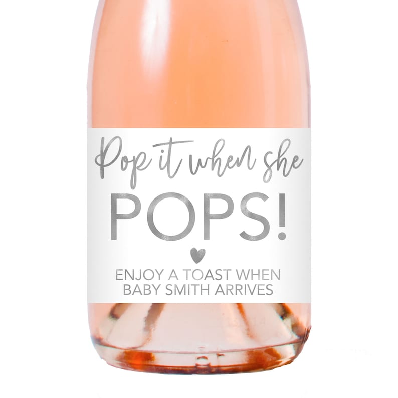 a bottle of wine with a label that says pop it when she pops