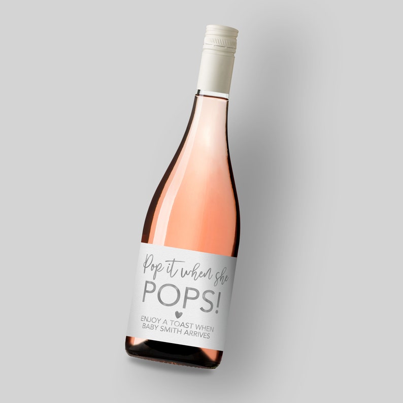 a bottle of pop pink wine on a gray background