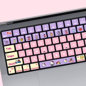 May include: A laptop keyboard cover featuring a light purple top row with various food and drink icons, pink letter keys with white lettering, and cream-colored modifier keys. The spacebar displays Hello Kitty characters and food graphics.