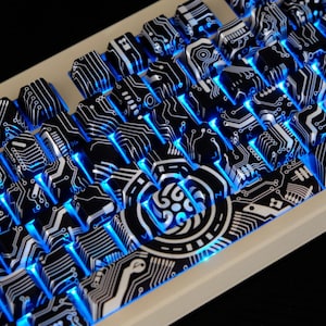 May include: A computer keyboard with black and white keycaps, each displaying a circuit board pattern. The keys are illuminated with blue light. The keyboard has a white frame.