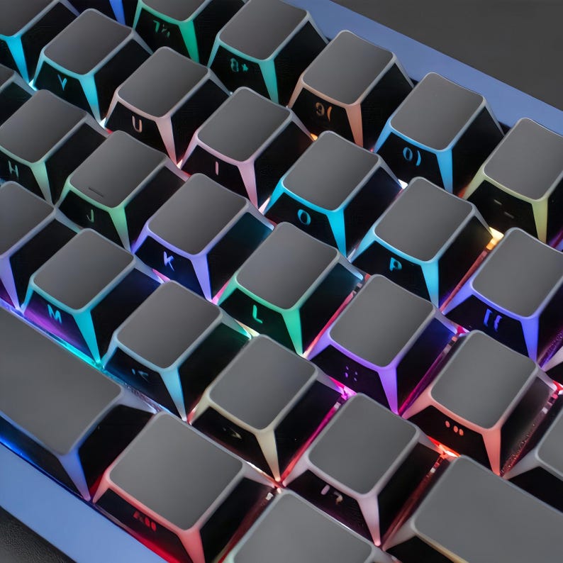 May include: A close-up shot of a mechanical keyboard featuring grey keycaps and multi-coloured LED backlighting. The keys are arranged in a grid, with letters and numbers visible. The lighting cycles through a range of colours, producing a bright effect.