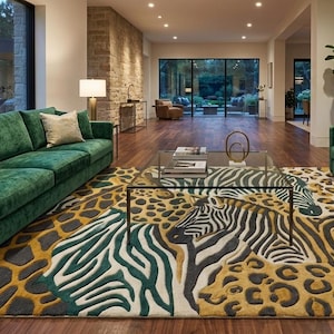 May include: A large area rug featuring a multi-colored animal print pattern with zebra stripes and leopard spots in shades of gold, dark green, and cream. The rug is positioned under a glass coffee table in a room with green sofas and armchairs.