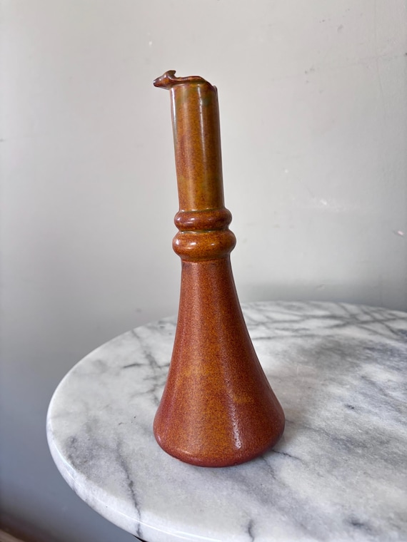 A hand-thrown ceramic olive oil cruet that turns an everyday countertop staple into a piece of functional pottery art — rustic, tactile, and totally unlike the glass bottles everyone else has.
