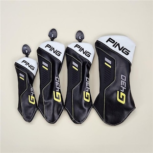 May include: Four black and white golf club head covers with the brand name "PING" in white block letters. The covers have yellow and gray accents and the text "G430" in yellow. The covers are in different sizes.