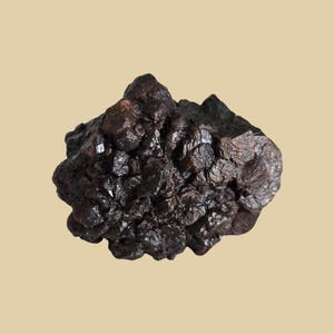 May include: A set of three ceramic mugs with a speckled, matte finish. The mugs are in shades of cream, light brown, and dark brown. Each mug has a rounded handle and a simple, minimalist design. Perfect for coffee or tea.