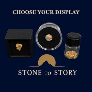 May include: A black square display box containing a gold nugget, a round clear container with a multi-colored stone bead, and a small glass vial filled with gold flakes. The text CHOOSE YOUR DISPLAY and STONE TO STORY is visible.