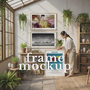 May include: A bright, airy room with framed art and plants. Two framed pictures hang on the wall, one a colorful painting and the other a black and white photograph. A framed poster with the word "Daiquiri" is propped up.