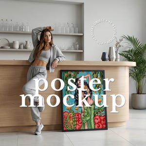May include: A framed poster mockup with a colorful illustration of a woman in a green dress. The poster is leaning against a wooden counter. The words "POSTER MOCKUP" are overlaid on the image.