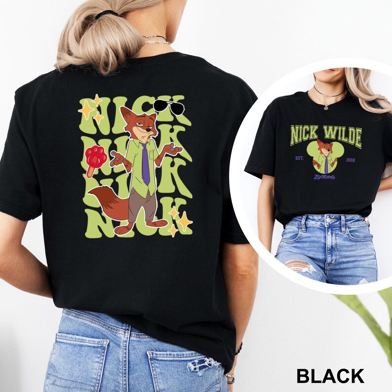 May include: Black t-shirt featuring a cartoon fox character with sunglasses and the text "NICK WILDE" in a retro font. The shirt also has a graphic of the character holding a flower. The shirt is paired with blue jeans.