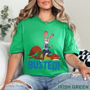 May include: Green t-shirt with a cartoon image of a rabbit police officer and a fox, with the word "BUSTED!" in blue. The shirt also has the words "IRISH GREEN" printed at the bottom.