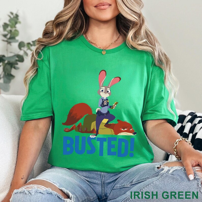 May include: Green t-shirt with a cartoon image of a rabbit police officer and a fox, with the word "BUSTED!" in blue. The shirt also has the words "IRISH GREEN" printed at the bottom.